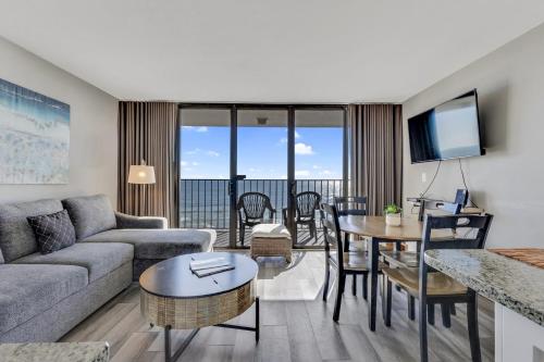 a living room with a couch and a table at 0703 Atlantic Retreat by Atlantic Towers in Carolina Beach