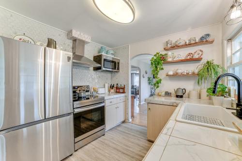 a kitchen with a stainless steel refrigerator and white cabinets at 1 Mi to Historic District Mtn-View Franklin Home in Otego