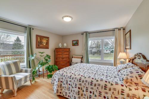 a bedroom with a bed and a chair and windows at 1 Mi to Historic District Mtn-View Franklin Home in Otego