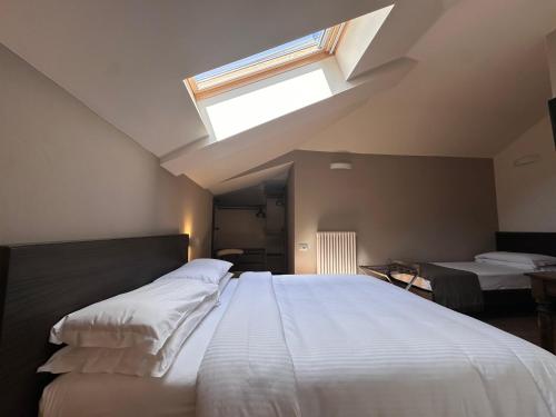 a bedroom with a large bed with a skylight at Hotel Ristorante San Giuseppe in Cernobbio