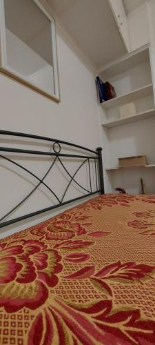 a bedroom with a bed with a rug on it at Nenita Home in Nénita