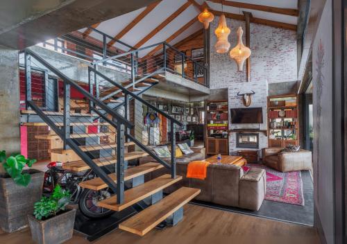 una sala de estar con una escalera de caracol en un loft en CLOUD 9 - KNYSNA DREAM HOME, en Knysna