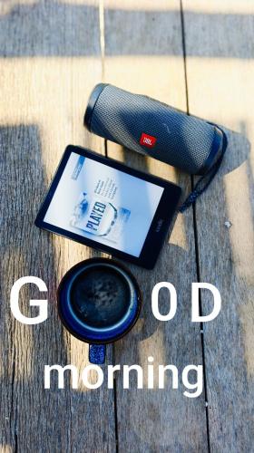 an ipad sitting on a wooden table with the words good morning at Suêrte cyprus in Akanthou