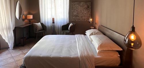 a hotel room with a bed and two chairs at Hotel Ristorante San Giuseppe in Cernobbio