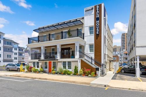 an apartment building with a balcony on a street at Surrey Beach House in Ventnor City