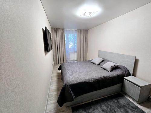 a bedroom with a bed with two pillows on it at Apartments in Bălţi