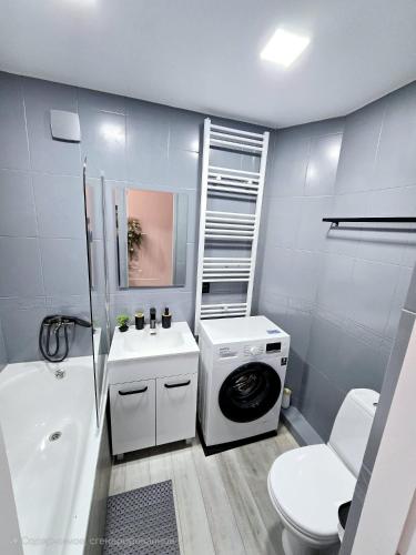 a bathroom with a washing machine and a washer at Apartments in Bălţi