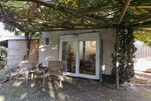 a screened in porch with a table and chairs at Boukje har Bêd en Brochje in Burgum