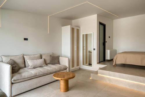 a living room with a couch and a bed at Anima Deluxe Suites in Nafplio