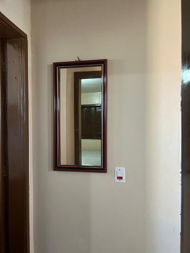 a mirror on a wall in a room at Ótima casa de praia a 2 quadras do mar in Tramandaí