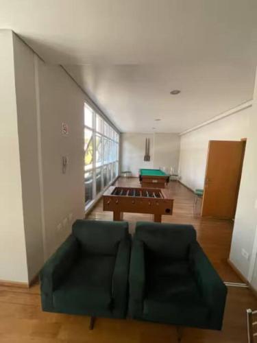 a living room with a couch and a table at STUDIO - ao lado do batel in Curitiba