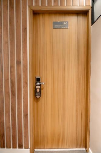 a wooden door with a sign on it at Fence by Bernalo Hotels in Medellín