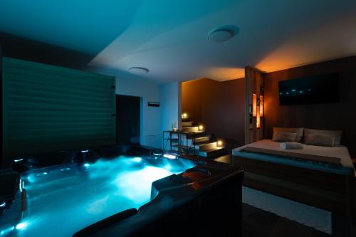 a hotel room with a jacuzzi tub with a bed at Green Valley Apartments in Zavrč