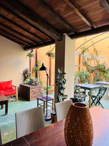 a patio with a wooden table and chairs and a table sidx sidx at Art Hotel Pietrasanta in Pietrasanta