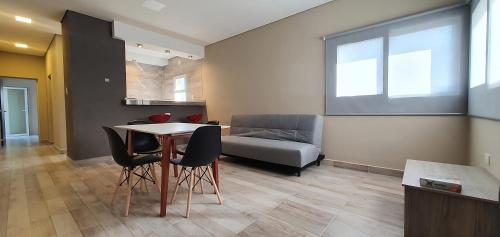 a living room with a table and a couch at Vi Hosting Cabañas Entre Cerros in Salta