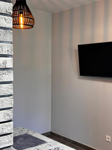a room with a flat screen tv on a wall at Apartments Black Sea in Odesa
