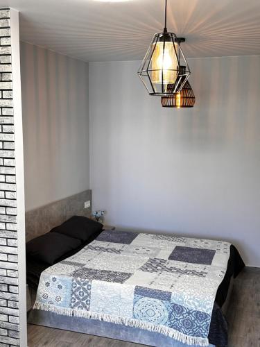 a bedroom with a bed with a quilt on it at Apartments Black Sea in Odesa