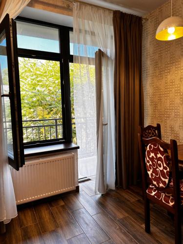 a room with a window and a chair in front of it at Apartments Black Sea in Odesa