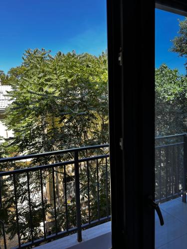 a view of a tree from a balcony at Apartments Black Sea in Odesa