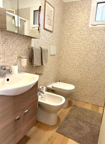 a bathroom with a sink and a toilet in it at Casa Sofia in Bologna
