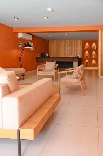 a living room with a couch and chairs at Leviu by Bernalo Hotels in Medellín