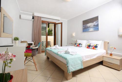 a bedroom with a large bed and a dining room at Asteras hotel in Hanioti