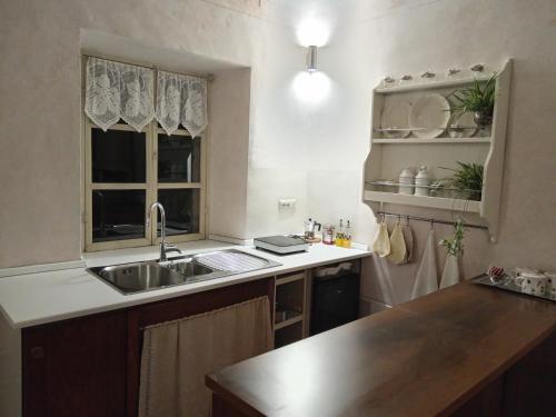 a kitchen with a sink and a counter top at Casa Vialardi in Brusasco