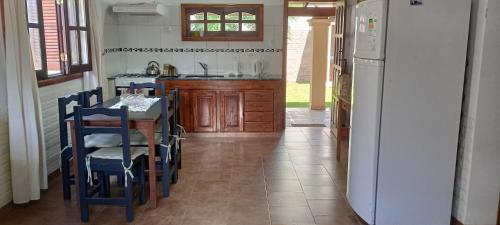a kitchen with a table and chairs and a refrigerator at La Elvira in San Antonio de Areco