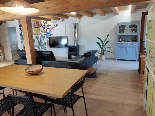 a living room with a table and a couch at Casa Rural El Pinche in Quincoces de Yuso