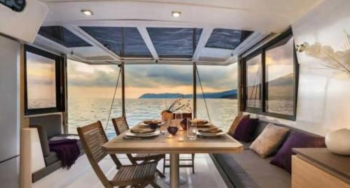 a dining room on a boat with a table at Centro Ibiza Catamaranes y Velero in Ibiza Town