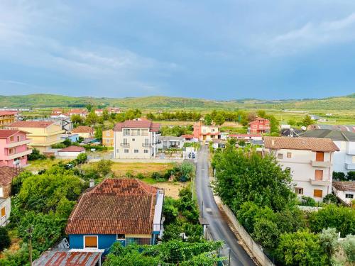 a small town with houses and a road at EasySleep City Center in Divjakë