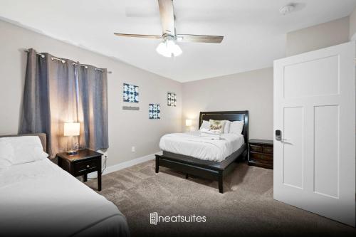 a bedroom with two beds and a ceiling fan at 4BR, 3Bath for 11, Near Ark, Plenty of Free Parking in Williamstown