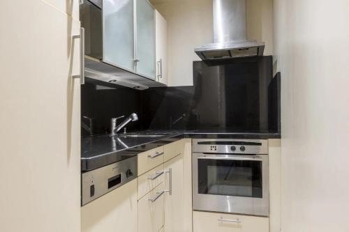 a kitchen with a sink and a stove at Foch triomphe in Paris
