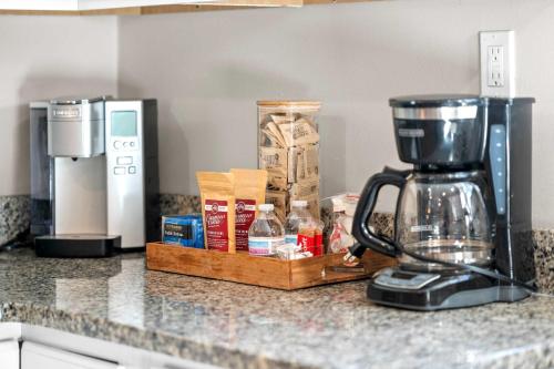 a kitchen counter with a coffee maker on a counter top at 4BR, 3Bath for 11, Near Ark, Plenty of Free Parking in Williamstown