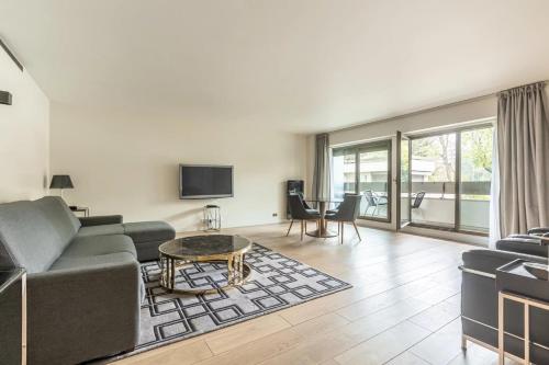 a living room with a couch and a table at Foch triomphe in Paris