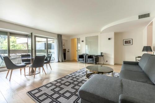 a living room with a couch and chairs and a table at Foch triomphe in Paris