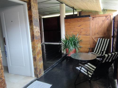 a room with a table and chairs and a door at PATASTAY in San Salvador de Jujuy