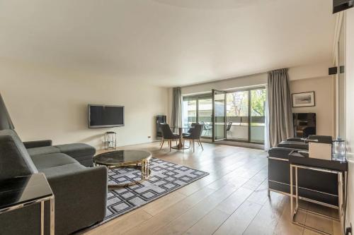 a living room with a couch and a table at Foch triomphe in Paris