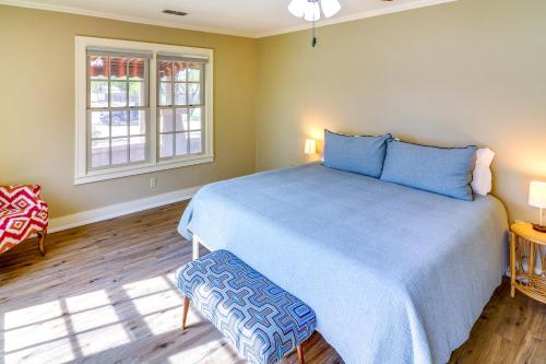 a bedroom with a blue bed and a window at Centrally Located Abilene Abode 2 Mi to Downtown! in Abilene