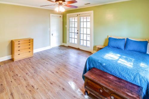 a bedroom with a blue bed and a wooden floor at Centrally Located Abilene Abode 2 Mi to Downtown! in Abilene