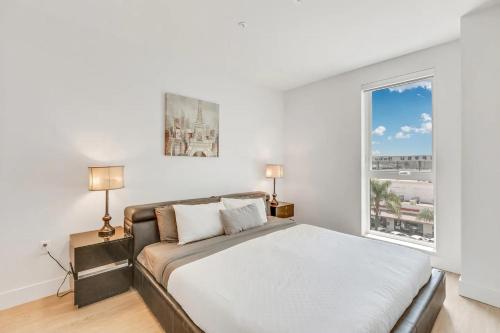 a bedroom with a bed and a large window at Apart Hotel near Dodgers Stadium in Los Angeles