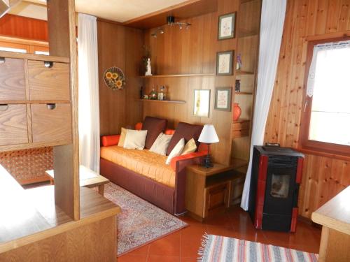 a bedroom with a bed and a stove in it at Casa Elda in Valdidentro