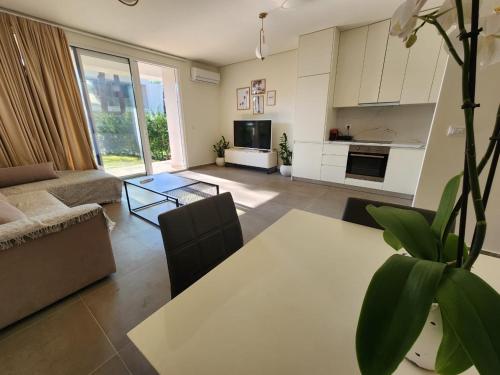a living room with a couch and a table at SanPietro Relax Apartment in Durrës