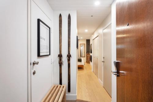 a hallway with a wooden door and a wooden bench at Cozy Cabin Vibes at Glacier Lodge in Whistler