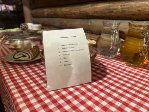 a sign sitting on top of a table at Gazdovský dvor B&B s Mini Wellness in Bešeňová