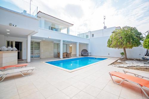a swimming pool in the backyard of a house at Beachfront Villa Larnaka Dhekelia with Pool in Pyla