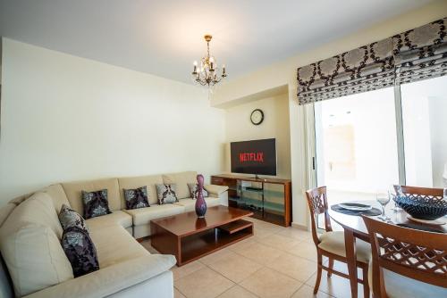 a living room with a couch and a table at Beachfront Villa Larnaka Dhekelia with Pool in Pyla