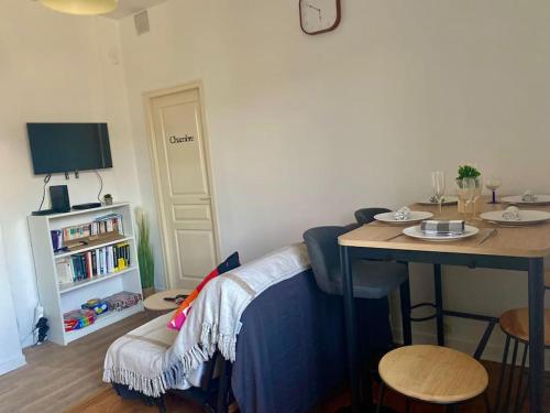 a living room with a table and a couch and a table and a tableablish at Le Jean Perrot rent4night grenoble in Grenoble