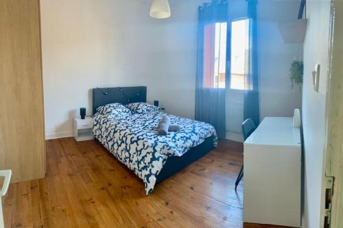 a bedroom with a bed and a wooden floor at Le Jean Perrot rent4night grenoble in Grenoble