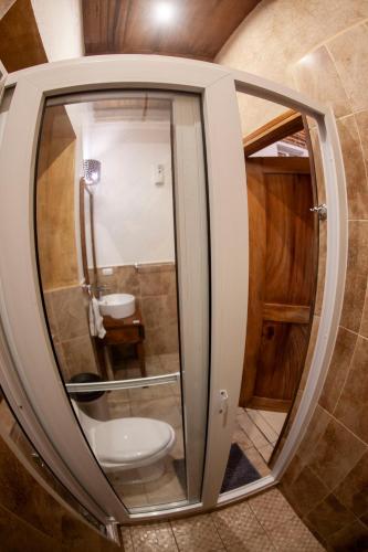 a bathroom with a toilet in a room at Hot Chipilin in Antigua Guatemala